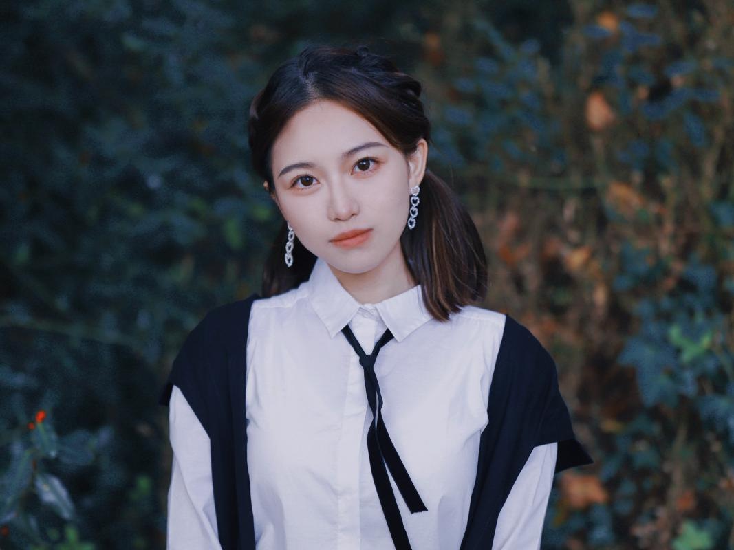 Zijia Tan standing outside and wearing Subfusc following her Matriculation Ceremony 