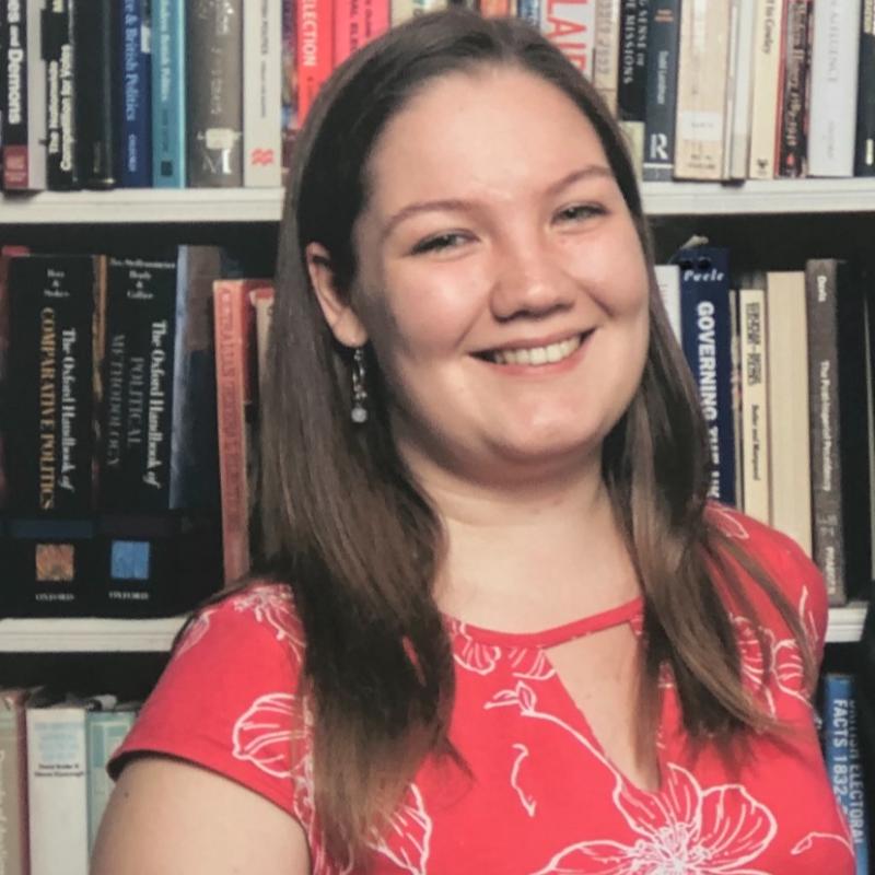 Eilidh Macfarlane stands in front of a bookcase