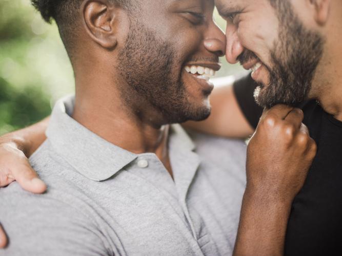 Image of two men embracing 