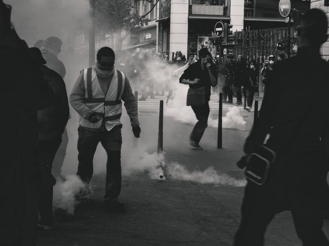 Black & white image of protesters and police