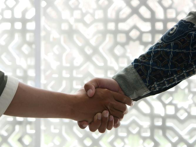 Image of two people shaking hands
