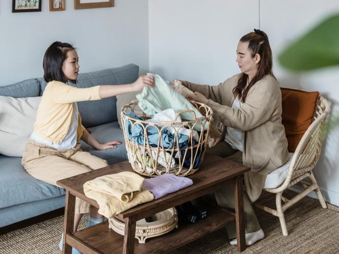 Image of woman and girl sorting laundry 