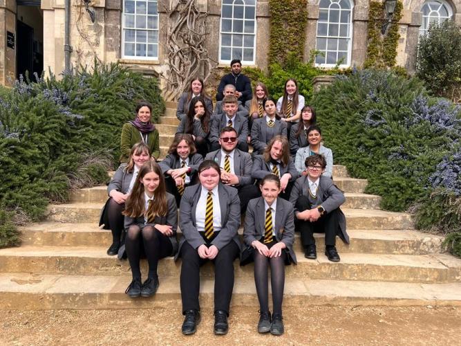 Students and teachers sit on the steps at Worcester College