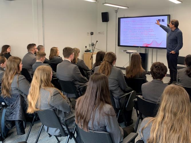 School students listen to a lecture for Professor Christiaan Monden