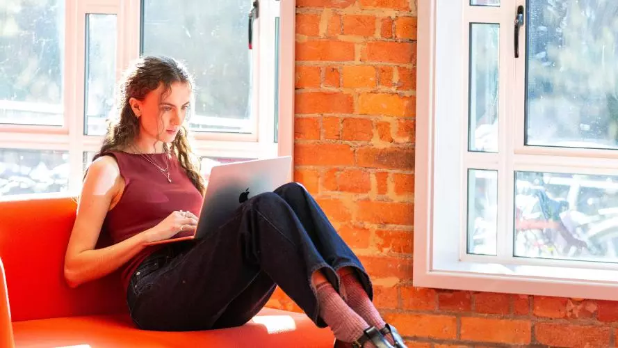 Image of a student sitting by the windows in the Department 