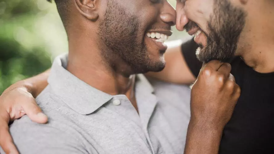 Image of two men embracing 
