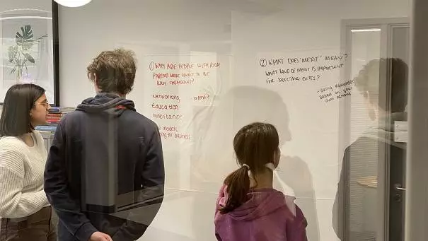 A-Level students looking at whiteboard