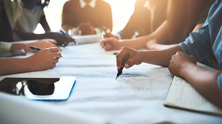 Several people work collaboratively at a table