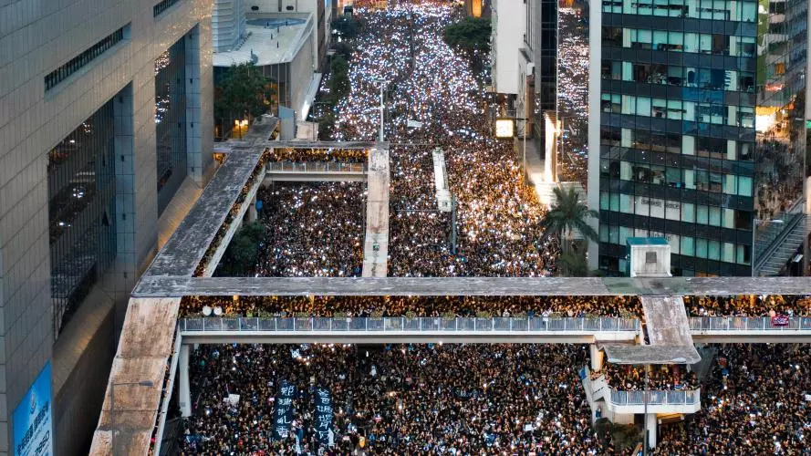 Crowds of people fill the street during a protest in Hong Kong
