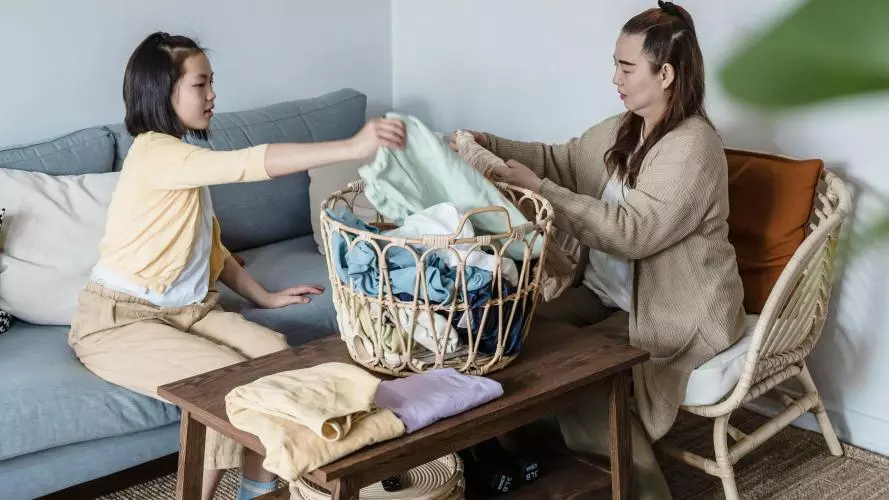Image of woman and girl sorting laundry 