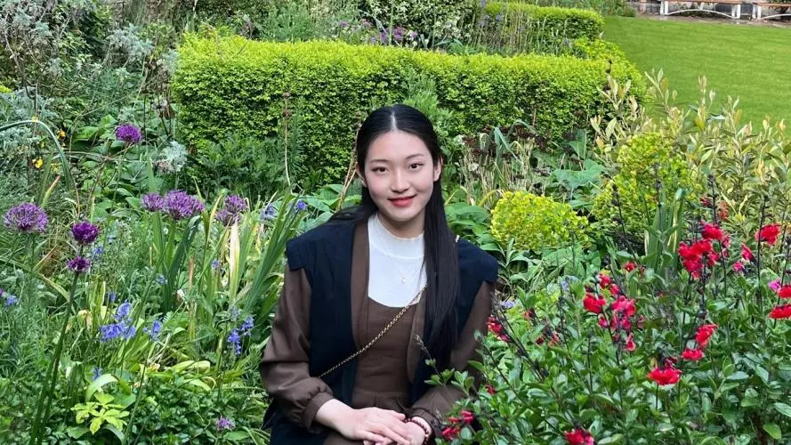 Yanjing Lu in the gardens of The Queen's College
