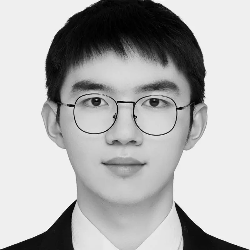 Jianghao Zhu has short black hair and glasses. He is wearing a dark suit, white shirt and tie