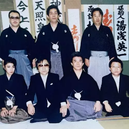 Seven members of a yakuza gang pose for a picture, including Nichimura Mako, the only woman to ever formally join a yakuza gang as a full member