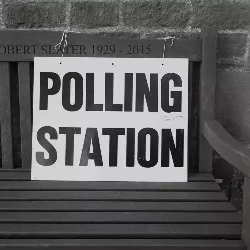 Polling Station sign on wooden bench