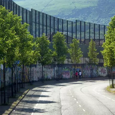 Image of Peace Wall alongside Cupar Way road in Belfast