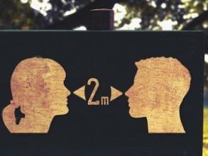 Silhouette heads of woman and man shown 2 metres apart
