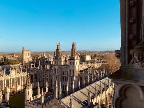 University of Oxford buildings against a clear blue sky