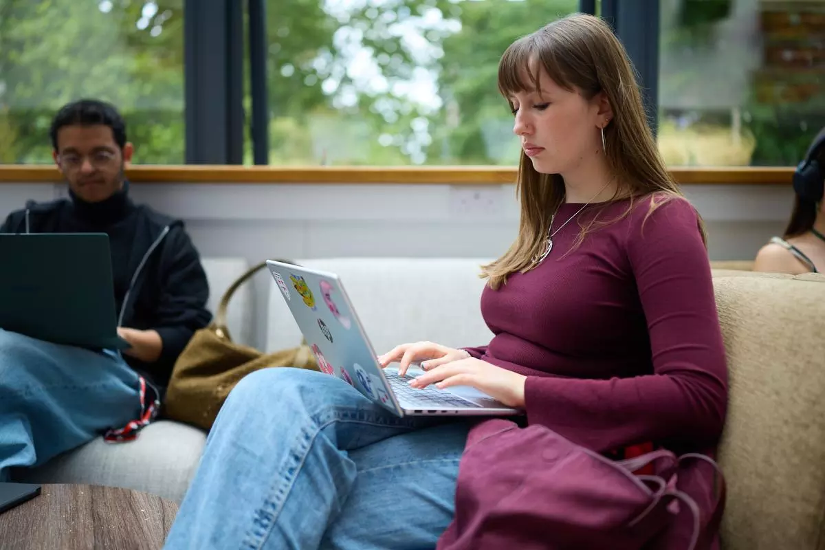 Image of female student typing on a laptop 
